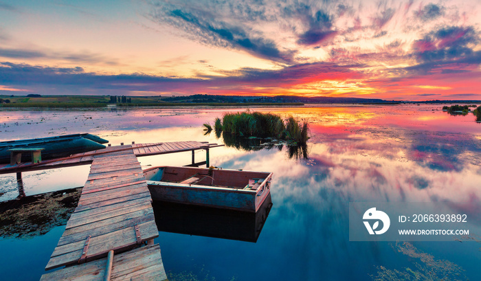 Calm evening scene of fishing lake. Stunning summer sunset on Ivachiv lake, Ternopil region location, Ukraine, Europe. Beauty of nature concept background.