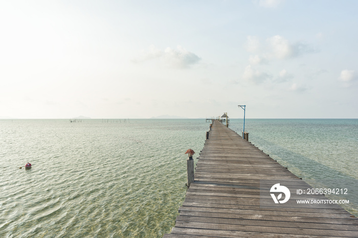 Long wooden bridge go to pavilion on the sea in beautiful tropical island, Thailand.