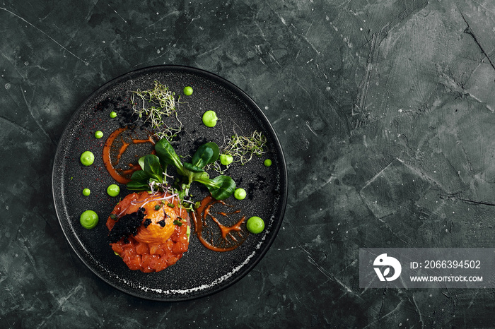 Salmon tartare with avocado and vegetables, a beautiful layout by the chef, a beautiful malohot - marble background. Food photo, advertising banner, copy space, Italian cuisine