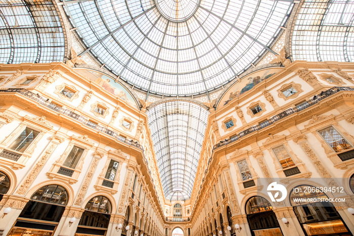 Interior with beautiful glass vaults in the famous Vittorio Emanuele shopping gallery in the center of Milan city.