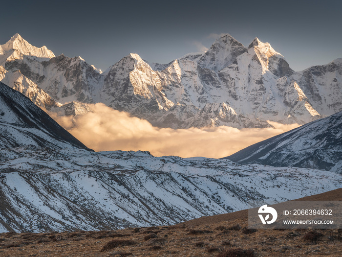 Lighting clouds between snow peaks in valley Khumbu in Nepal