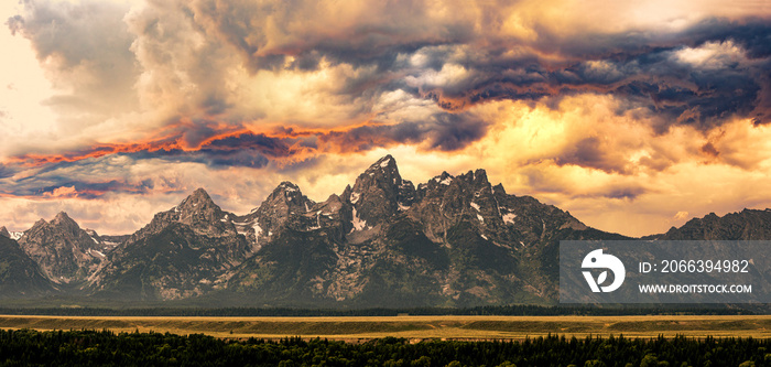 Dramatic Sunset over the Grand Teton Mountain Peaks in Wyoming, Evening Panorama of an Approaching Summer Storm