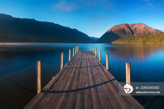 Romantic wharf on Lake Rotoiti, view overlooking misty Saint Arnaud Ridge, all part of Nelson Lakes National Park in north od South Island of New Zealand Beautiful pier on sunrise