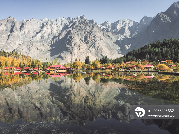 Landscape view of reflection in the water of lower Kachura lake with mountains in Karakoram range in the background. Skardu, Gilgit Baltistan, Pakistan.