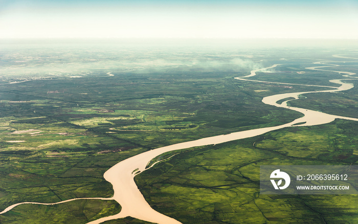 Landscape aerial view of colorful Amazon rivers, forest with trees, jungle, and fields