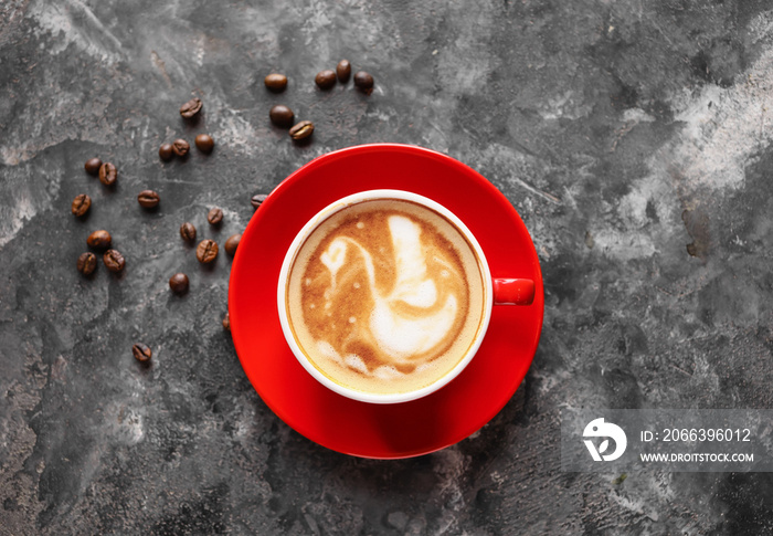 Cup of coffee with latte art on grunge background