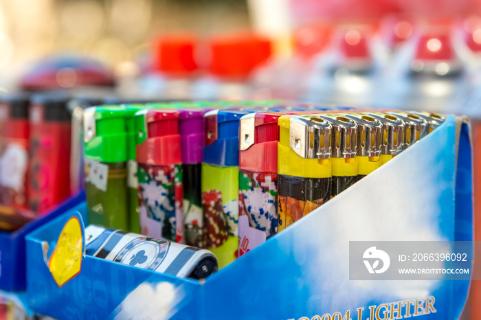 A pack of colorful lighters in the market multicolored gas lighter in package for sale.plastic gas lighter closeup Colorful lighters close-up, Beautiful colorful gas lighter.