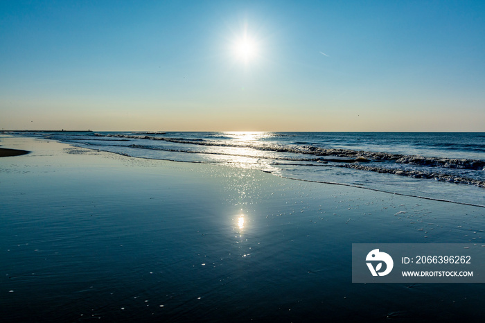 Sunny day on North sea beach in Netherlands in Schegeningen, tourist and vacation destination in Europe