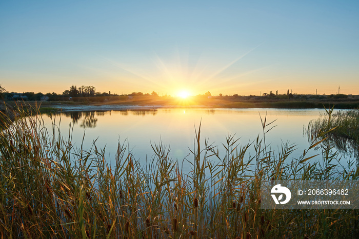 beautiful sunset or sunrise above the river at summer evening.