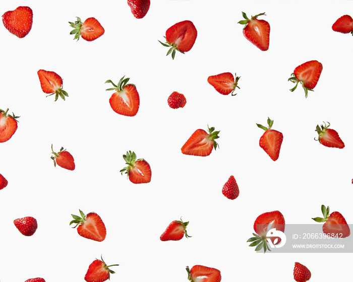 Pattern of fresh halves of ripe strawberries on a gray background