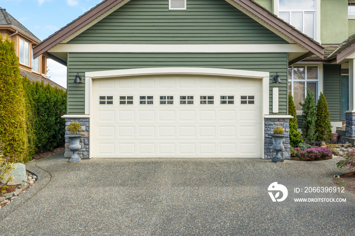 Luxury house with a two-car garage on a sunny day in Vancouver, Canada