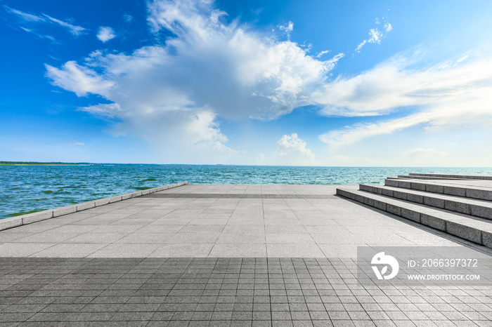 Empty square floor and lake landscape under the blue sky.