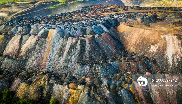 landscape with multicolored rock dumps from quarries, aerial photo