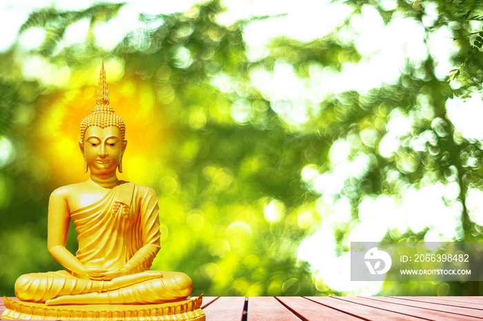 Buddha statue with aura on yellow sky background