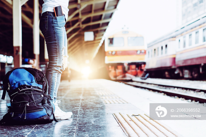 Solo woman backpacker traveler plan safety trip low cost budget summer holiday after coronavirus. Empty tourist on train railway platform. Use bus train sustainable environmental friendly transport