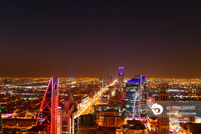 Panorama view to the skyline of Riyadh by night, with skyscrapers in the background and busy traffic on the streets of Riyadh, the capital of Saudi Arabia