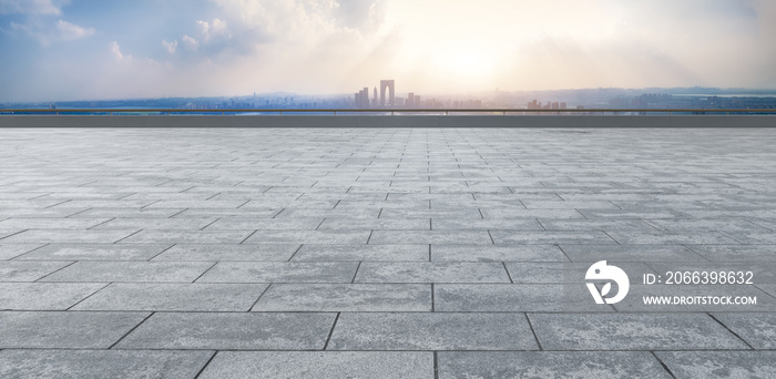 Empty brick floor with city skyline background