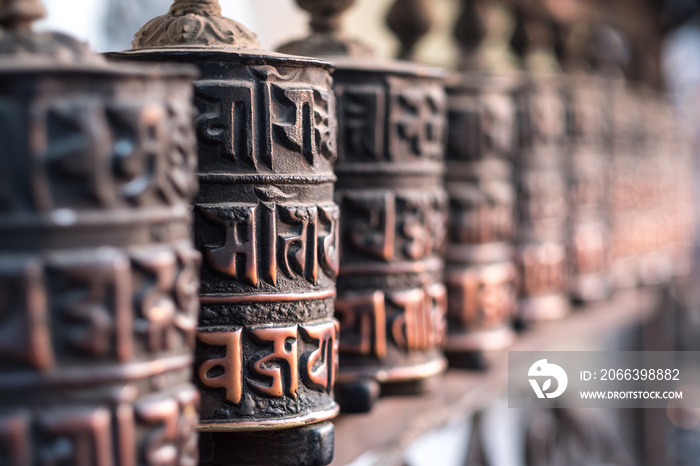 Close-up of ancient prayer wheel in Buddhist temple, Kathmandu, Nepal.