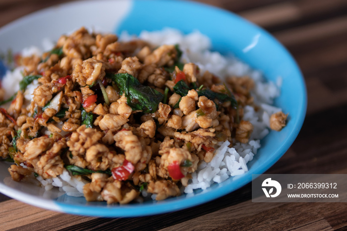 Popular Thai Dish, Pad Kra Prao Kai or Spicy Fried Chicken with Basil topped on Jasmine Rice