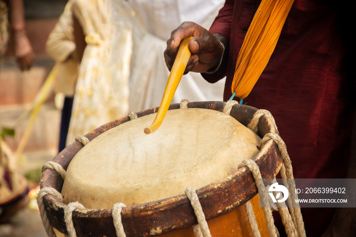 Close up of Hands performing Indian art form Chanda or chande cylindrical percussion drums playing during ceremony