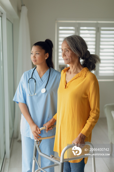 Healthcare worker and a woman using a walking aid