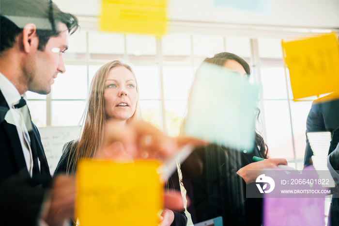 Group of successful business teamwork. Brainstorm meeting with colorful sticky paper note on glass w