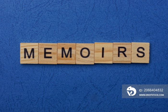 word memoirs made from brown wooden letters lies on a blue table