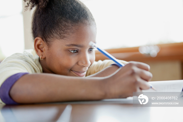 Pretty, young student writing at desk