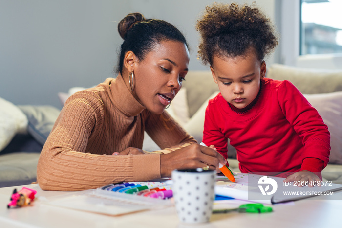 Happy family. Mother and daughter together paint.