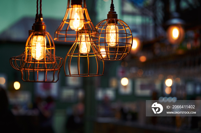 Old rustic lights hanging from the ceiling with a blurred background