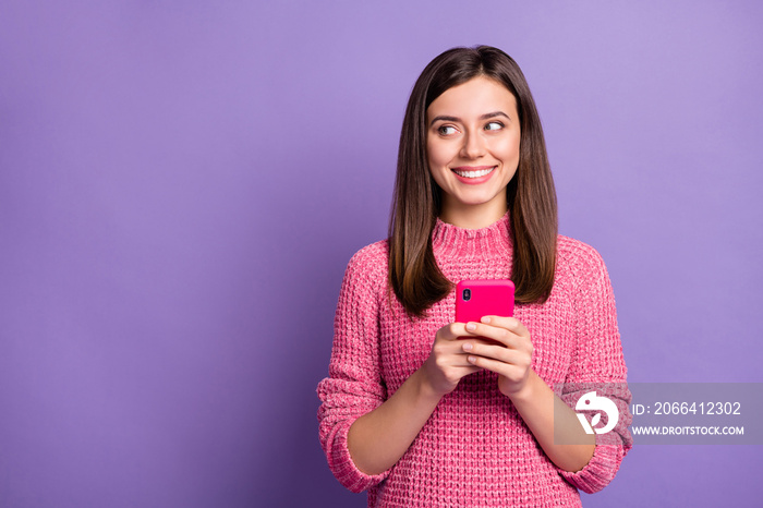 Photo portrait of curious smiling girl typing comment in internet looking blank space isolated on br