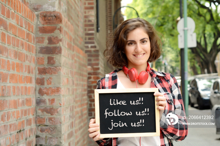 Woman holding chalkboard. Social media concept.