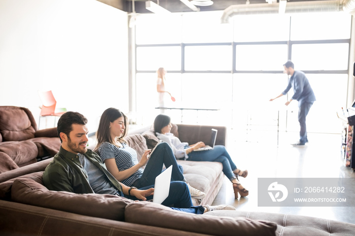 Business people relaxing in lounge room