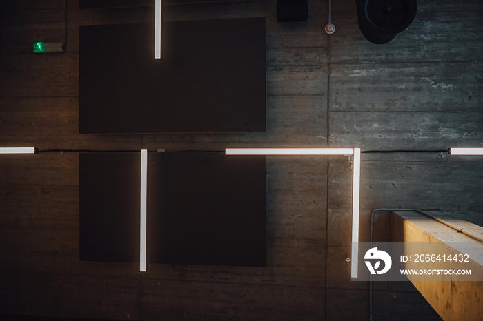 View on modern led lightning hanging from ceilings, industrial building concrete texture