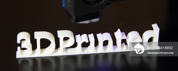 a 3D printer printing the text  3d printed