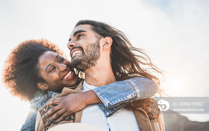 Multiracial couple having tender moments outdoor - Caucasian man and african woman having fun togeth