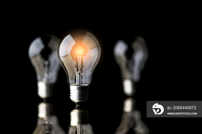 creativity startup business ideas concept with glow light bulb on black background