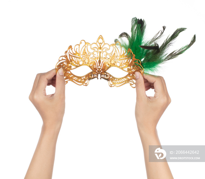 Hand holding beautiful of carnival mask with feather isolated on a white background.