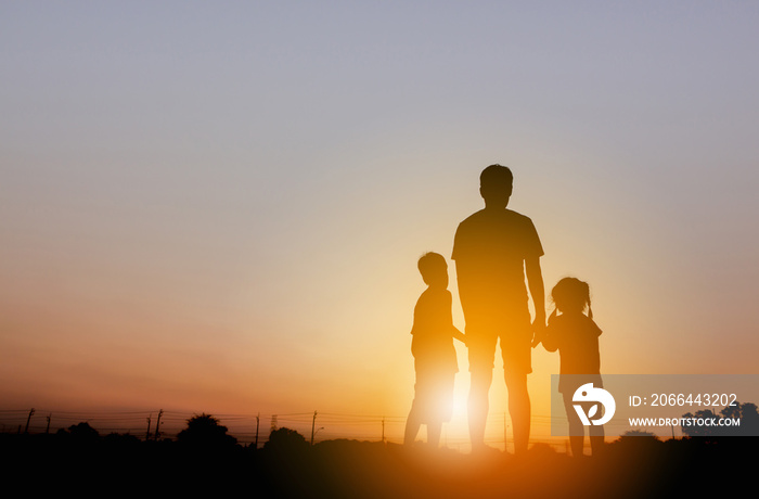 Silhouette of Father and two kids having fun on sunset, Happy family concept.