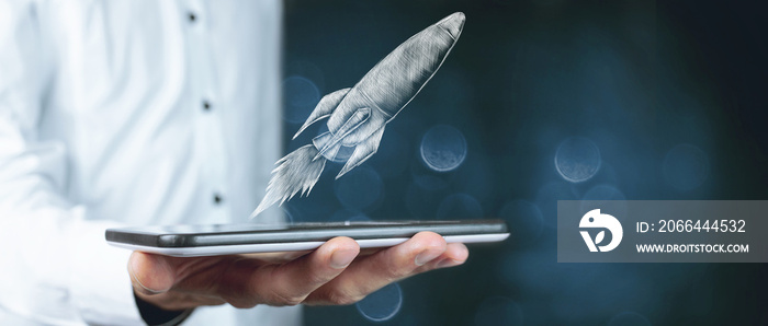 illustrated rocket. hand-drawn. man holding a tablet