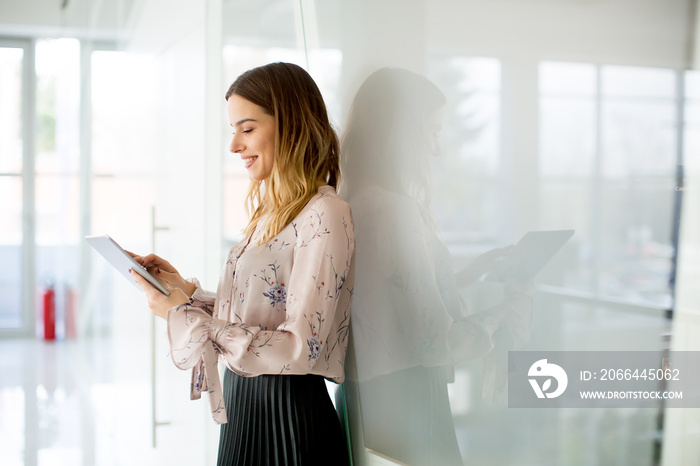 Young businesswoman with tablet in office