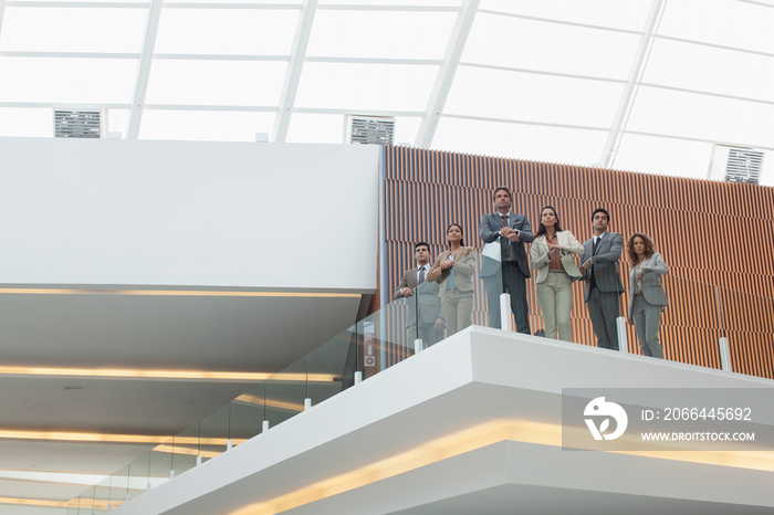 Portrait business people on modern office balcony