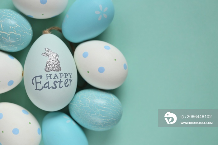 Easter holiday. Blue and white  Easter eggs with bunny on a light blue background.Spring festive eas