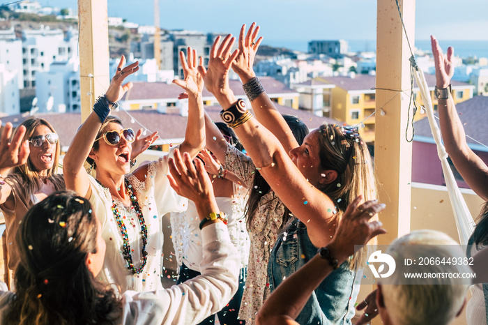 Group of happy young people caucasian women with terndy fashion clothes celebrate together with a lo