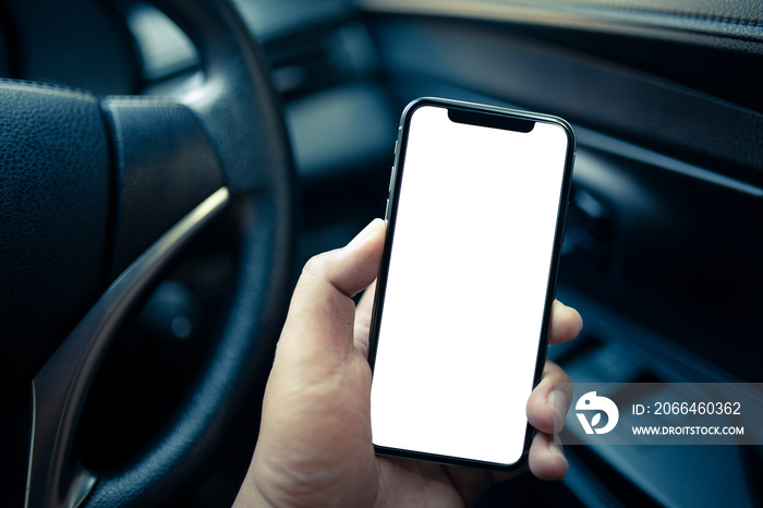 Man hand holding  smartphone with blank screen in the car