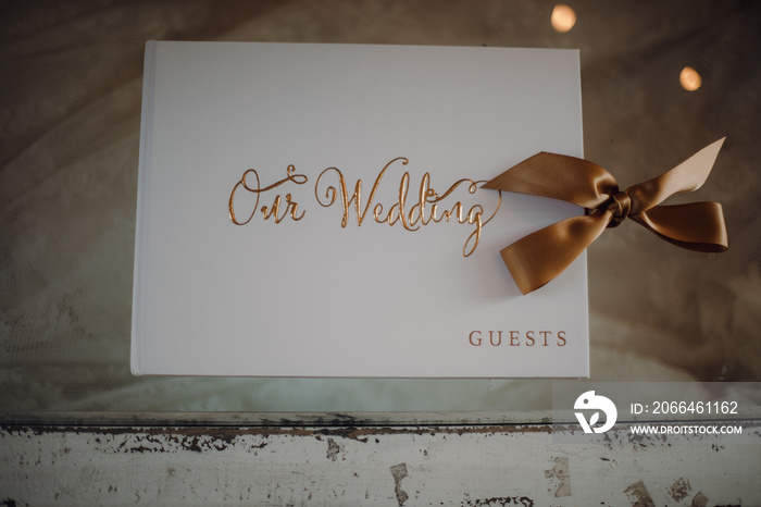 Top view of a guest book for a wedding ceremony on a vintage-style wooden table