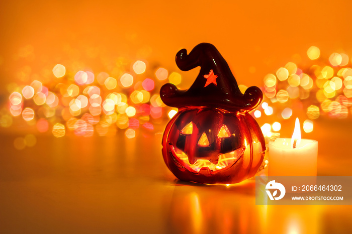 Halloween pumpkin with candlelight and bokeh background