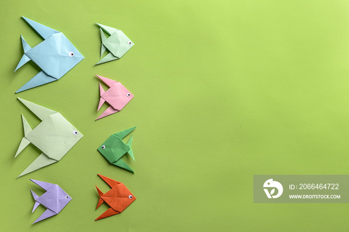 Origami fish on color background