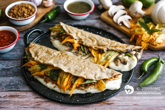 Mexican chicharrón quesadilla with oaxaca cheese and squash blossom, traditional food from the city 