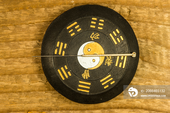 acupuncture needle on Chinese Taoism symbol